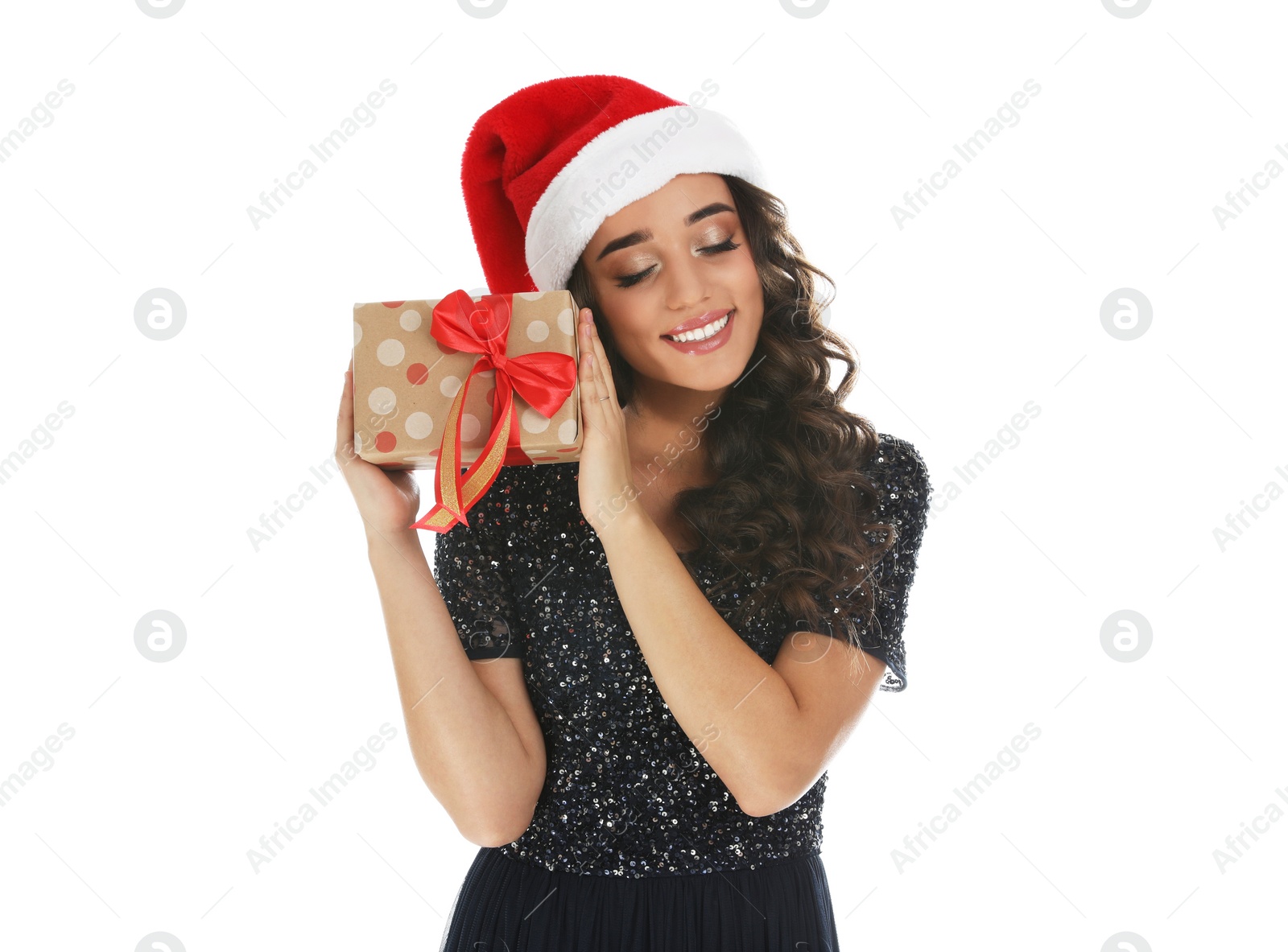 Photo of Beautiful woman in Santa hat with Christmas gift on white background