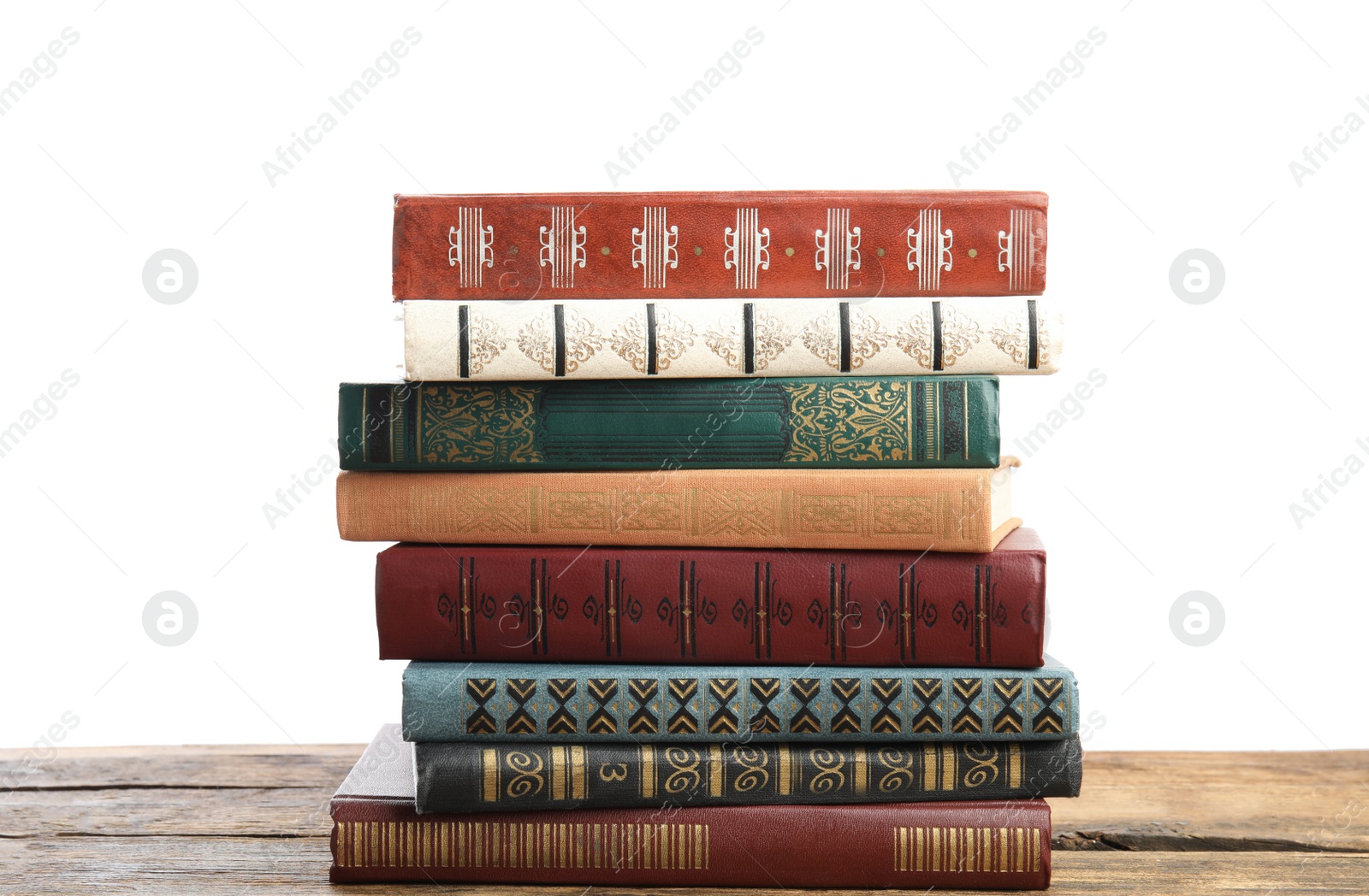 Photo of Stack of old vintage books on wooden table against white background