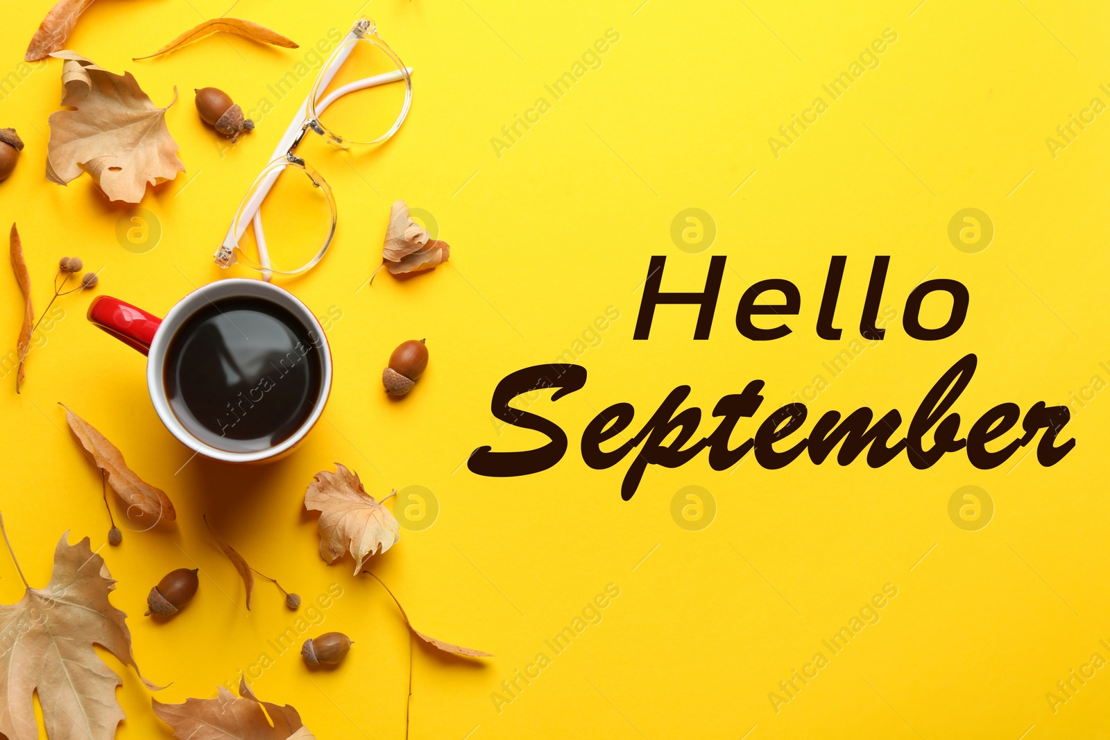 Image of Text Hello September, cup of coffee, glasses and autumn leaves on yellow background, top view