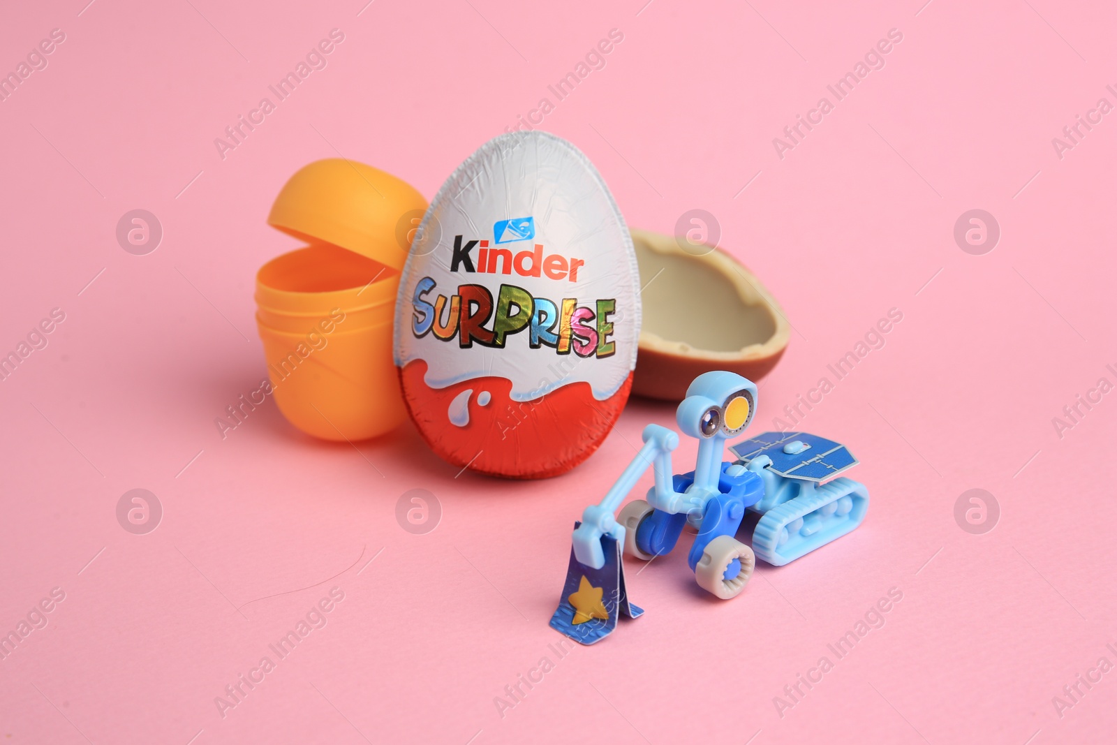 Photo of Sveti Vlas, Bulgaria - July 3, 2023: Kinder Surprise Eggs, open plastic capsule and toy on pink background