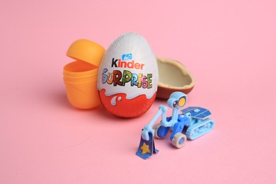Sveti Vlas, Bulgaria - July 3, 2023: Kinder Surprise Eggs, open plastic capsule and toy on pink background