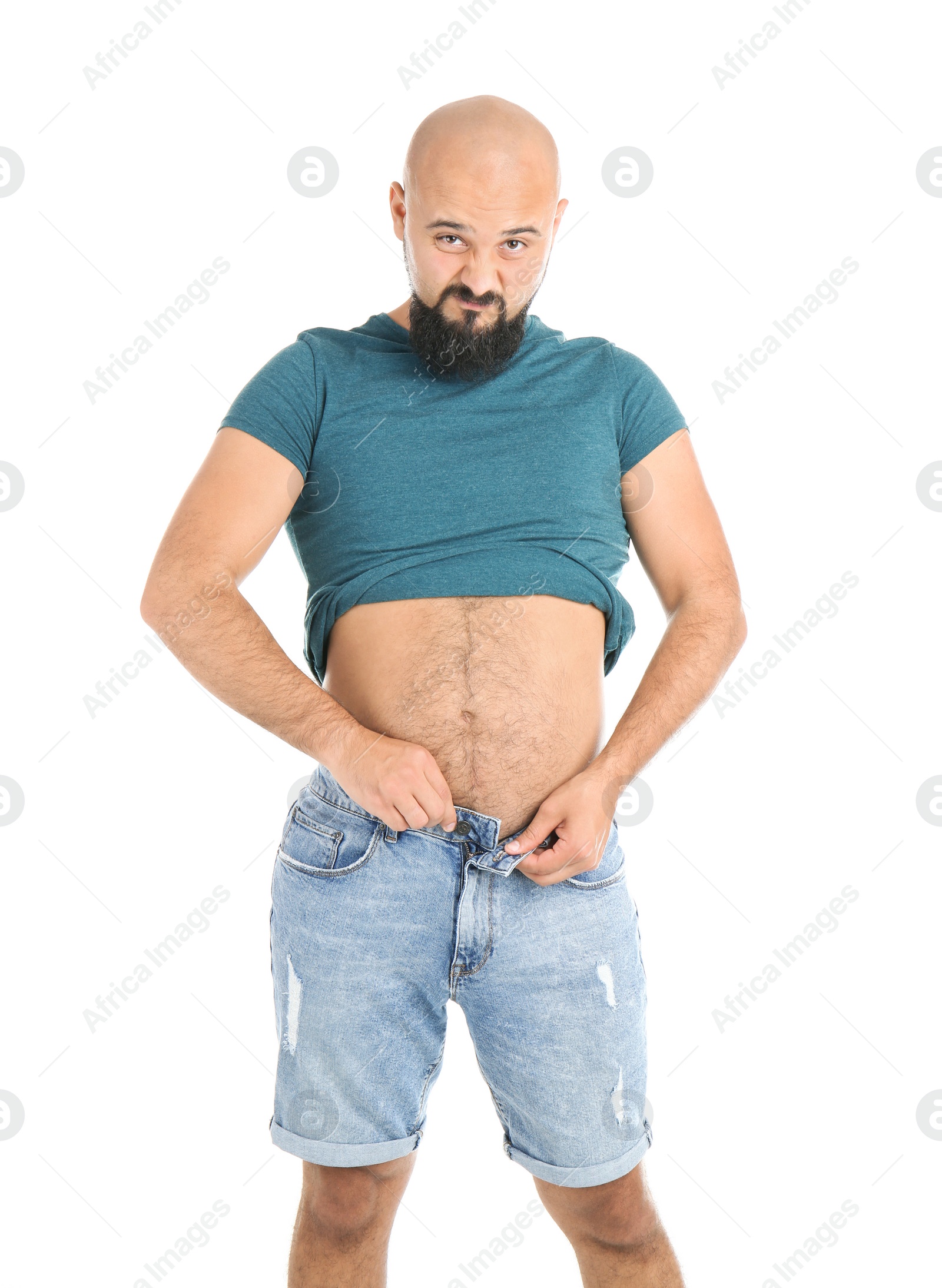 Photo of Portrait of overweight man in small shorts on white background
