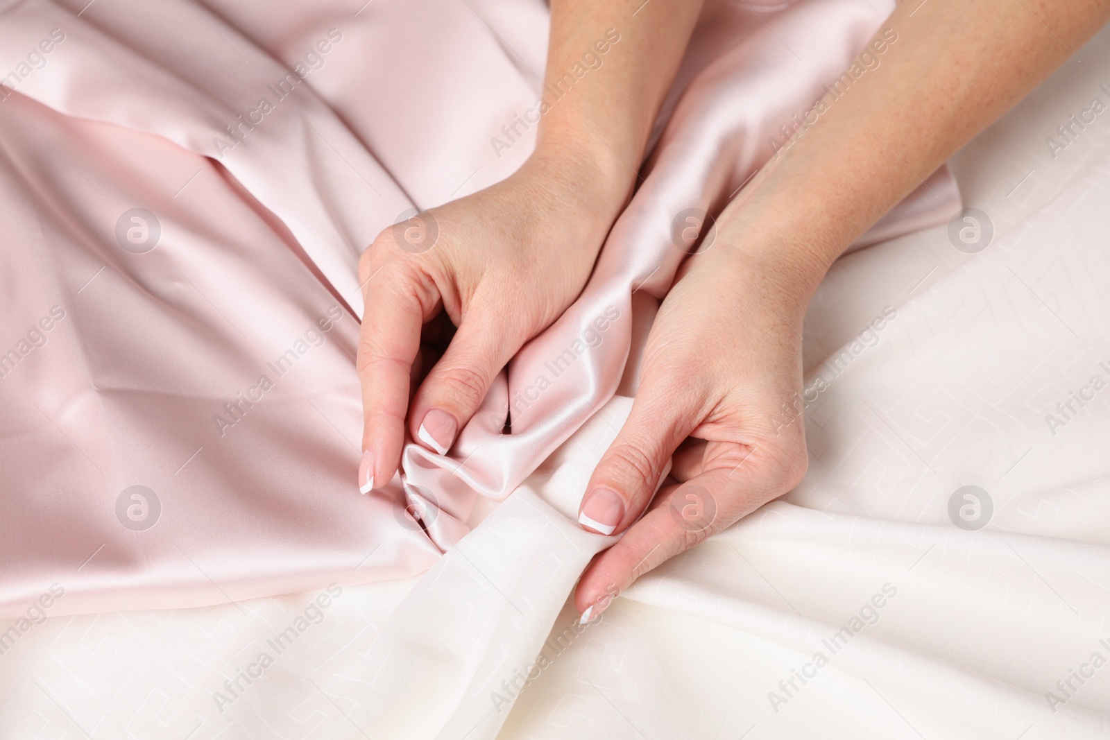 Photo of Woman touching smooth silky fabric, closeup view