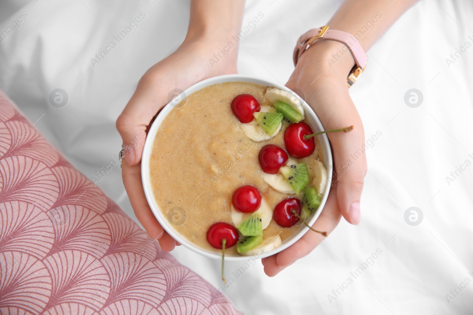 Photo of Young woman with bowl of healthy smoothie, closeup