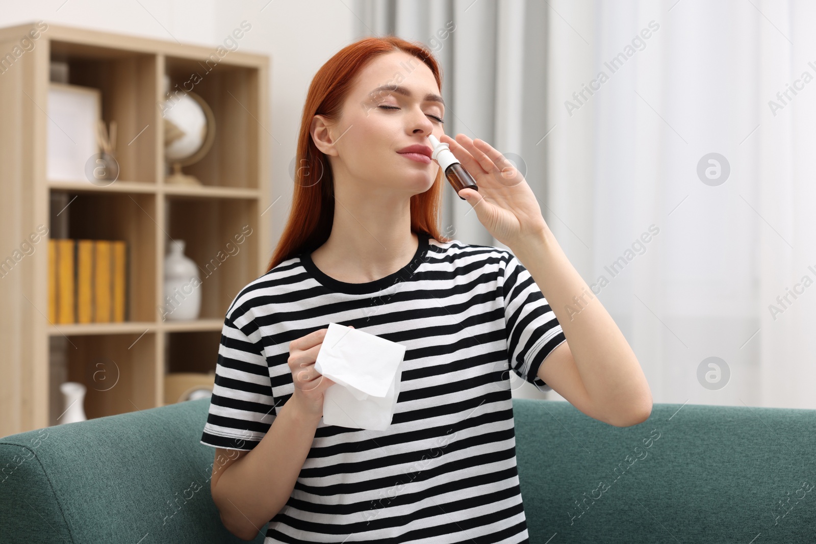 Photo of Medical drops. Woman with tissue using nasal spray at home