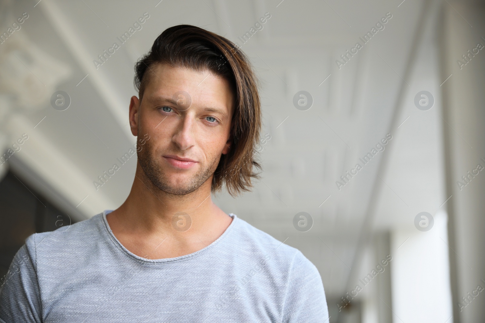 Photo of Portrait of handsome young man indoors, space for text