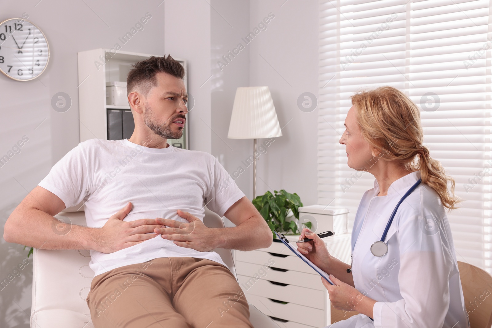 Photo of Doctor listening to patient's complaints during consultation in clinic