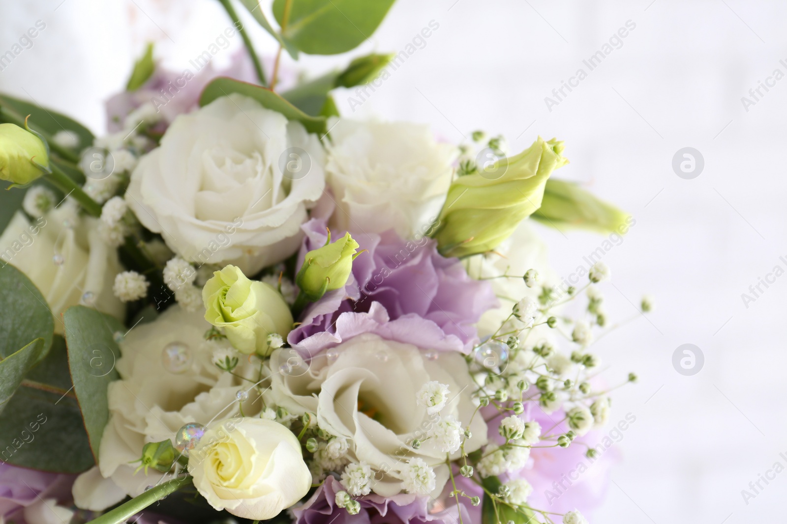 Photo of Beautiful wedding bouquet with Eustoma flowers on light background, closeup