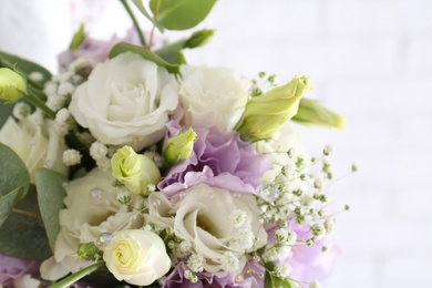 Beautiful wedding bouquet with Eustoma flowers on light background, closeup