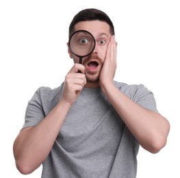 Surprised man looking through magnifier glass on white background