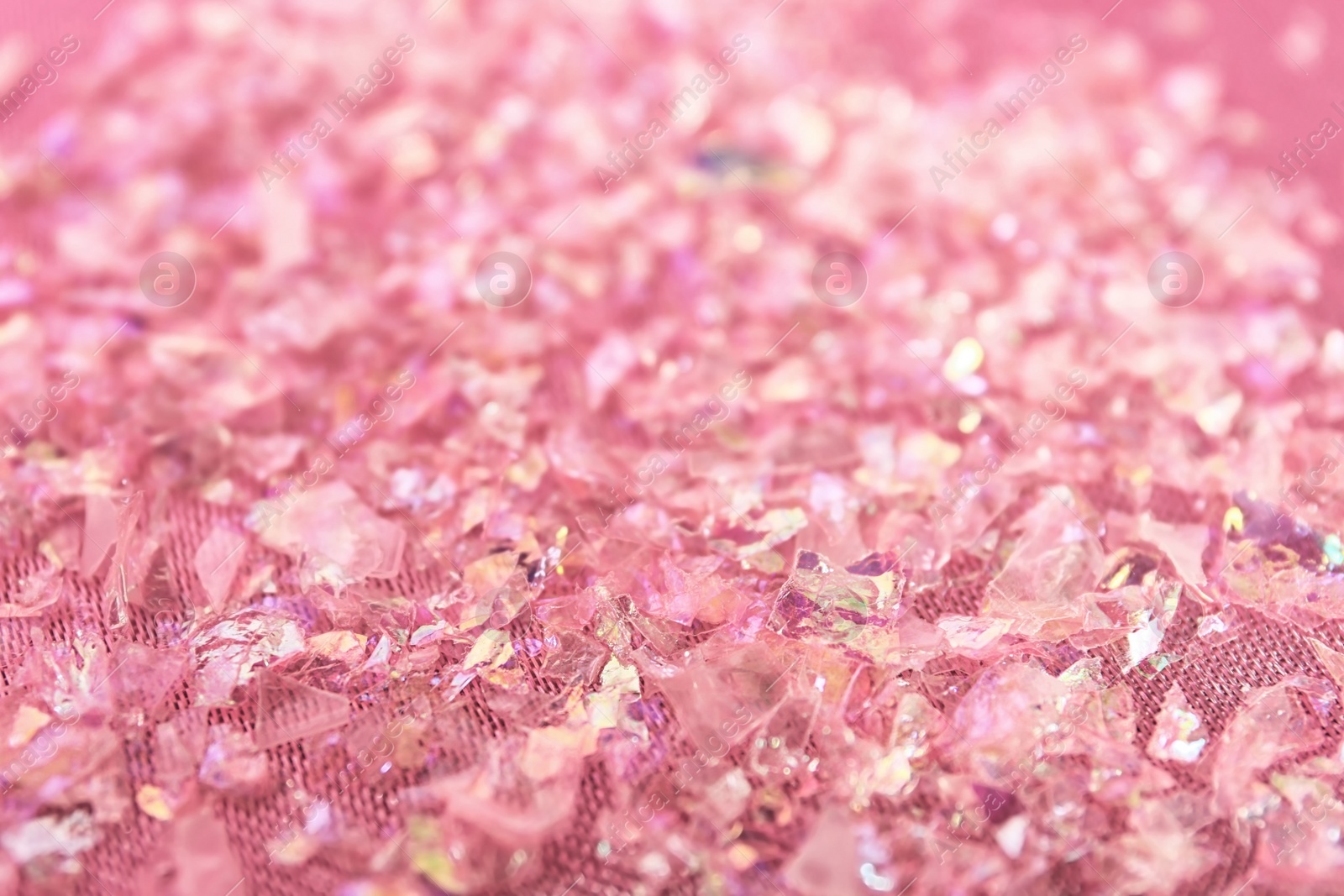 Photo of Pieces of shiny rose material on fabric, closeup