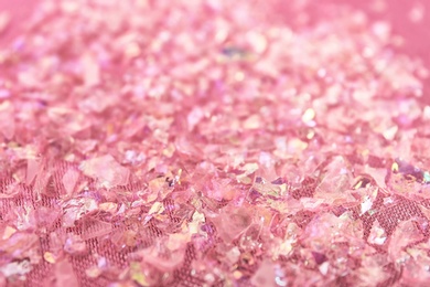 Photo of Pieces of shiny rose material on fabric, closeup