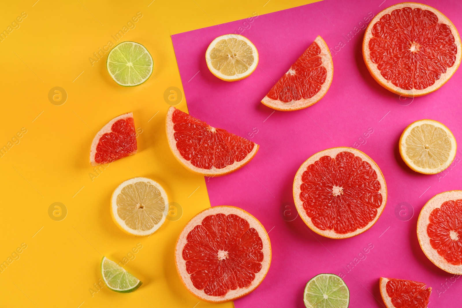 Photo of Flat lay composition with tasty ripe grapefruit slices on color background