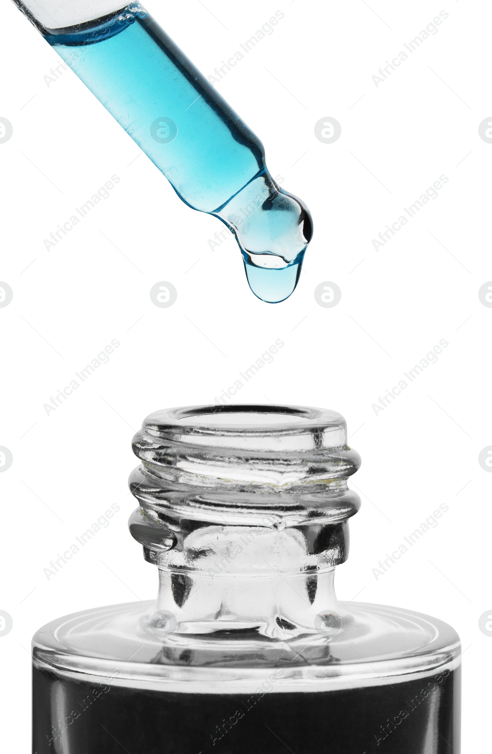 Photo of Dripping light blue facial serum from pipette into glass bottle on white background, closeup