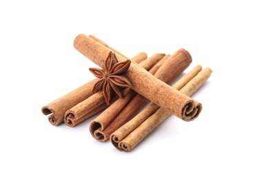 Aromatic cinnamon sticks and anise on white background