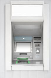 Photo of Modern automated cash machine with screen outdoors