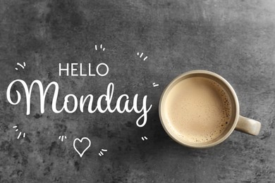 Image of Cup of hot aromatic coffee and phrase Hello Monday on grey background, top view