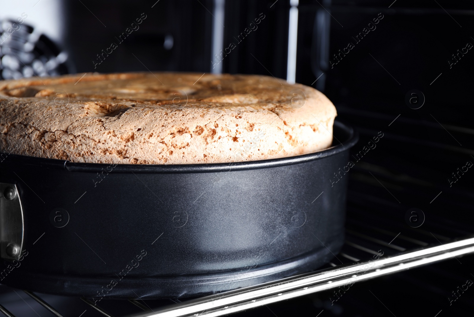 Photo of Delicious fresh homemade cake on rack in oven