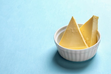 Photo of Dish with fresh butter on color background, space for text