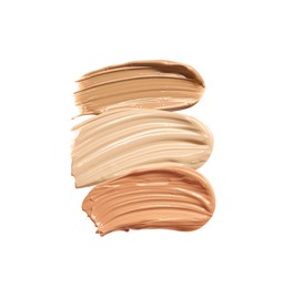 Different shades of liquid skin foundation on white background, top view