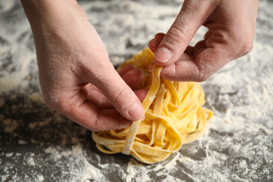 Photo of Woman holding pasta at table, closeup view