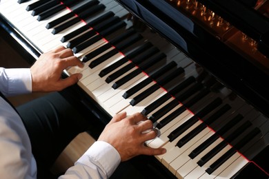 Photo of Man playing piano, above view. Talented musician