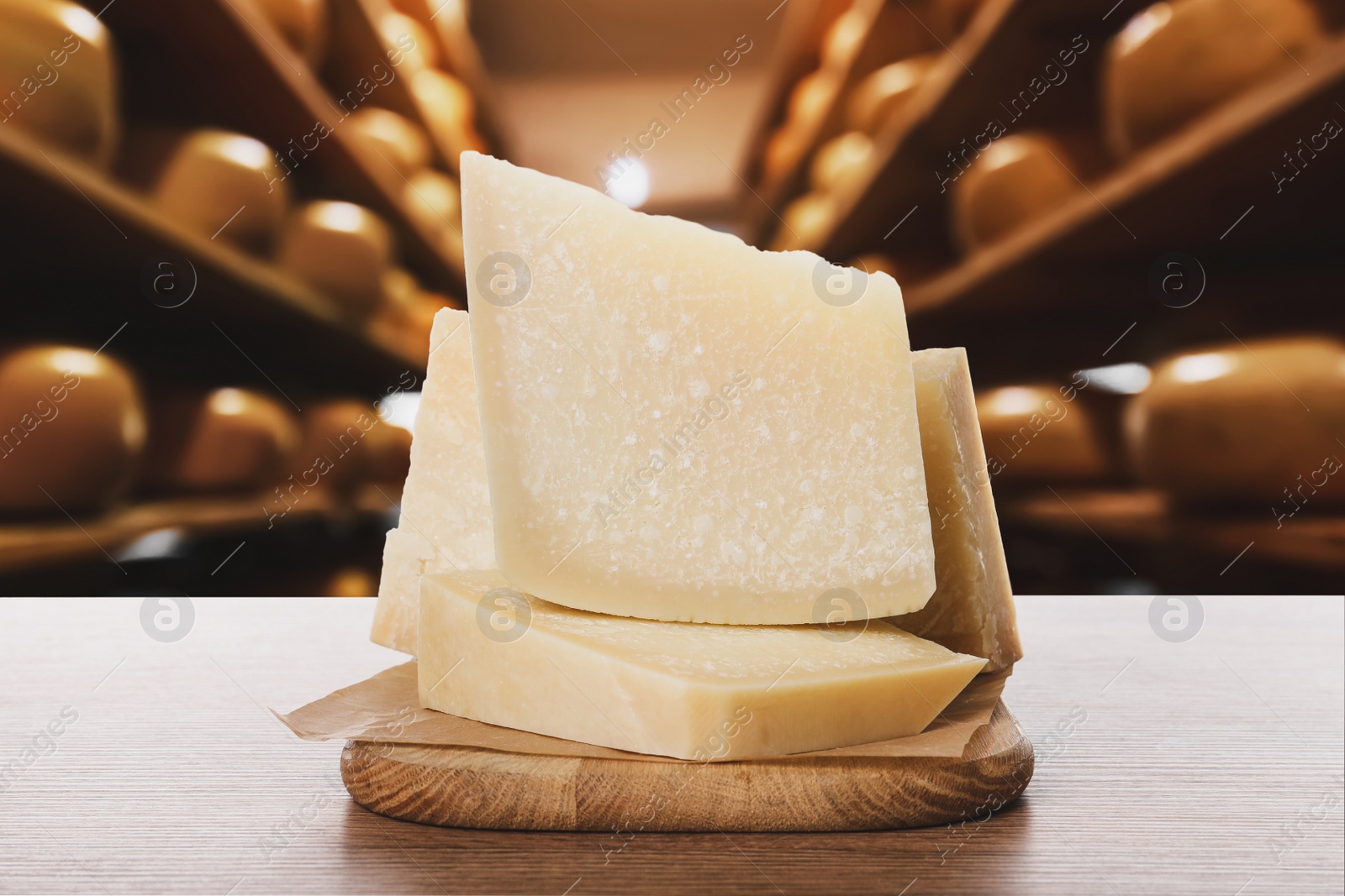 Image of Delicious parmesan cheese on wooden table in warehouse