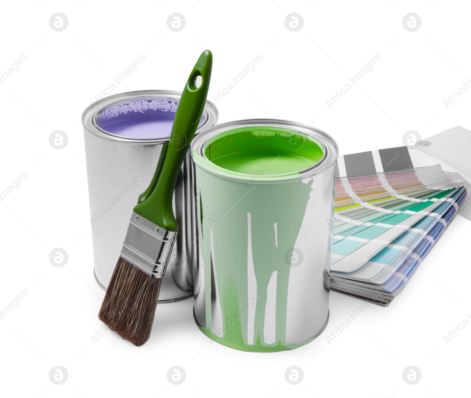 Photo of Cans of lilac and green paints, palette and brush isolated on white