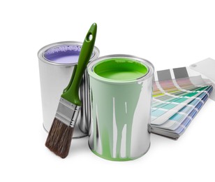 Photo of Cans of lilac and green paints, palette and brush isolated on white