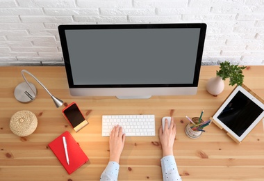 Photo of Woman using modern computer at table, top view