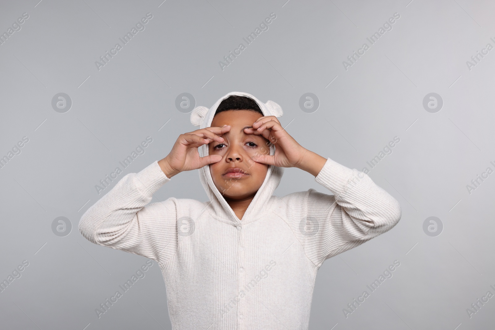 Photo of Sleepy boy in pajama on grey background. Insomnia problem