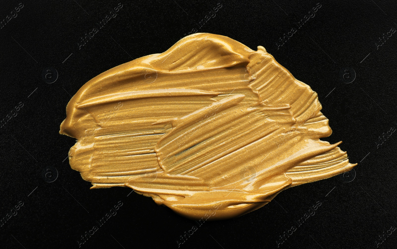 Photo of Golden paint brush strokes on black background