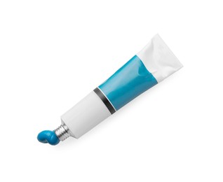 Tube with blue oil paint on white background, top view
