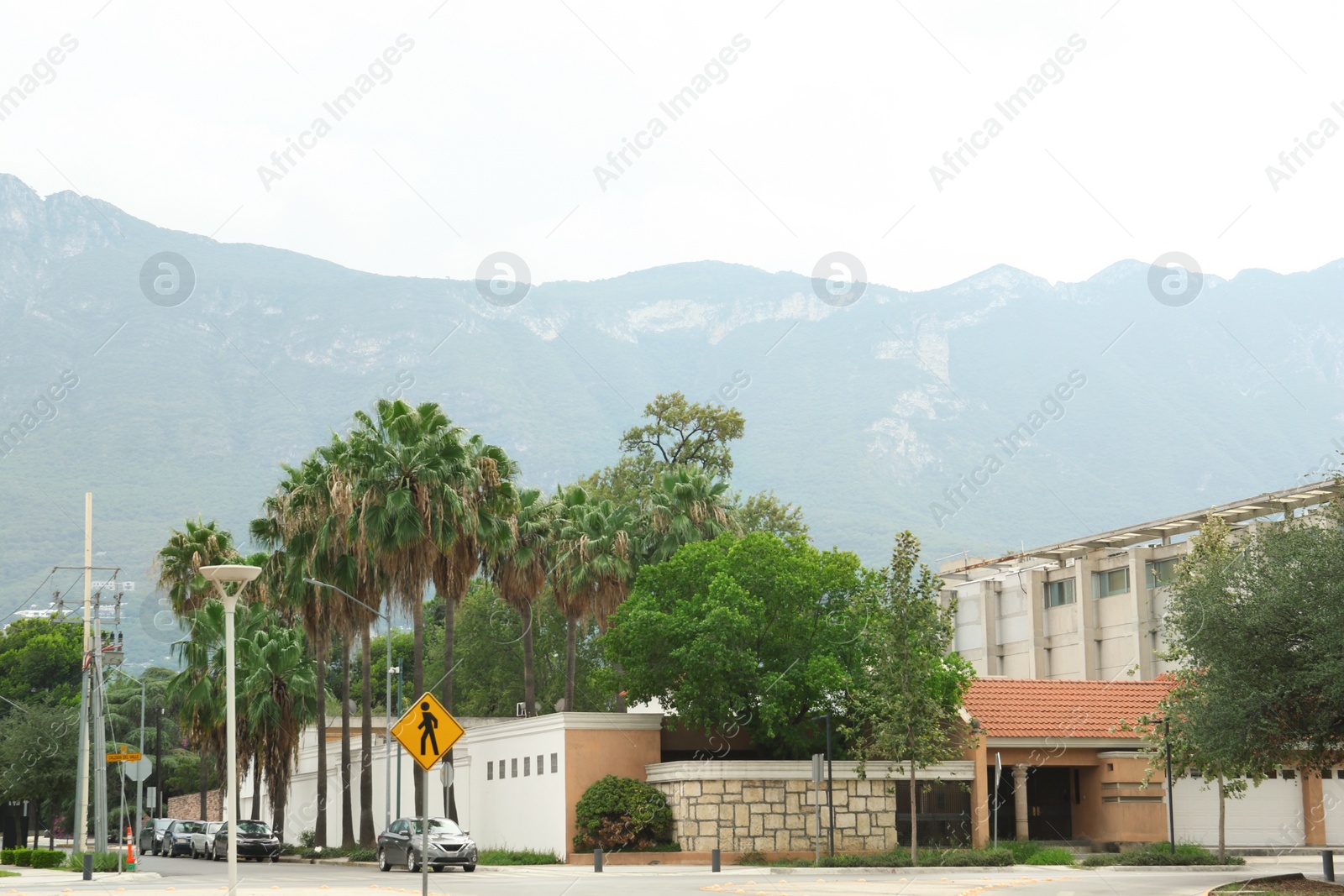 Photo of Mexico, San Pedro Garza Garcia - August 26, 2022: City street with buildings and cars near beautiful mountains