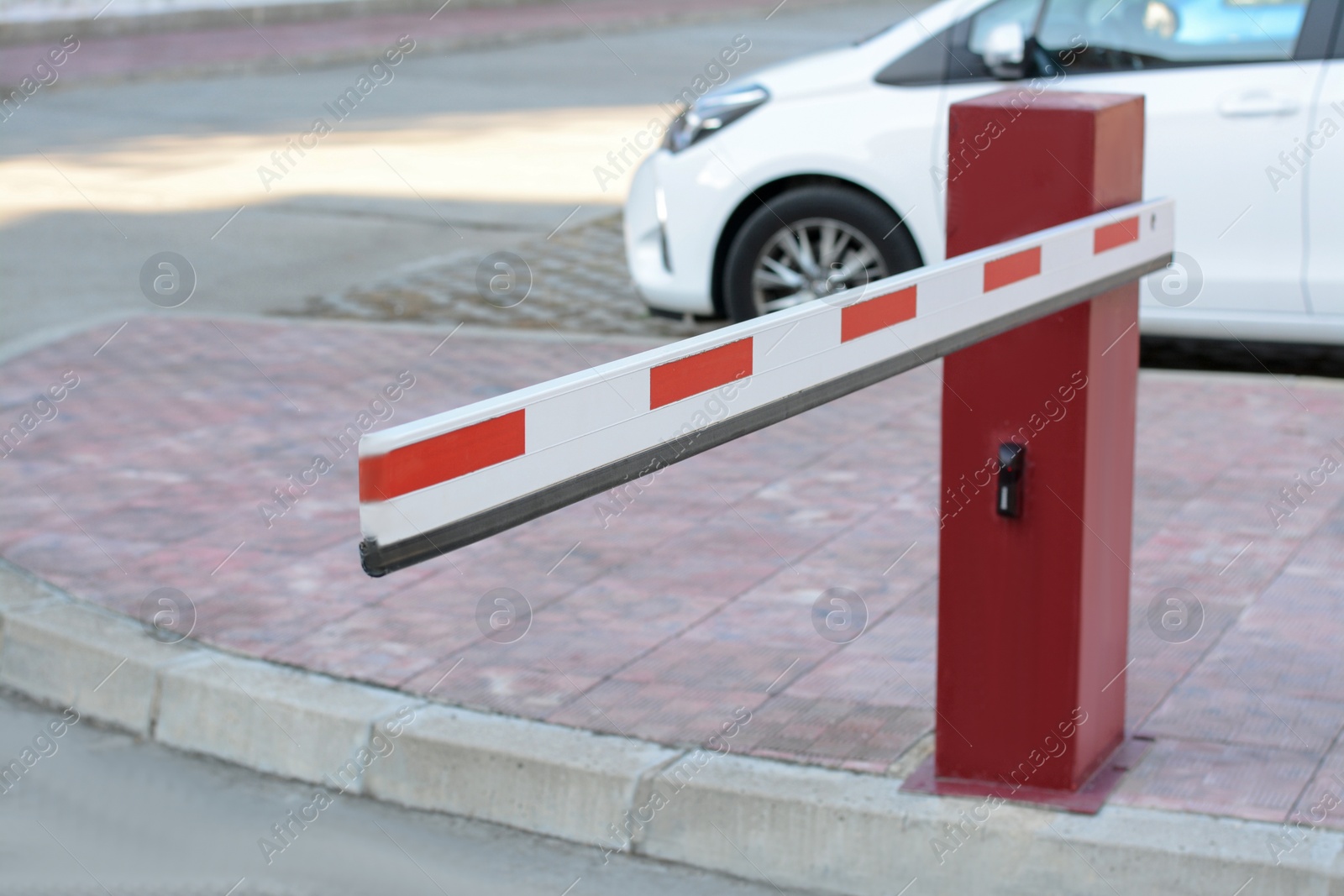 Photo of Closed boom barrier near road on autumn day outdoors