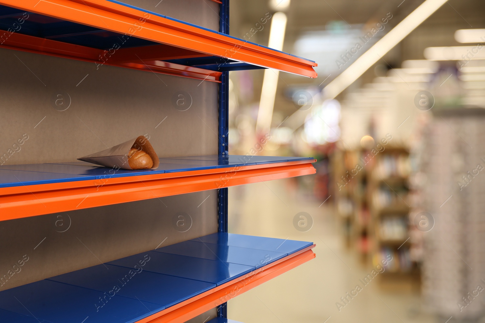 Image of Almost empty shelves in supermarket, closeup. Product deficiency due to social panic 