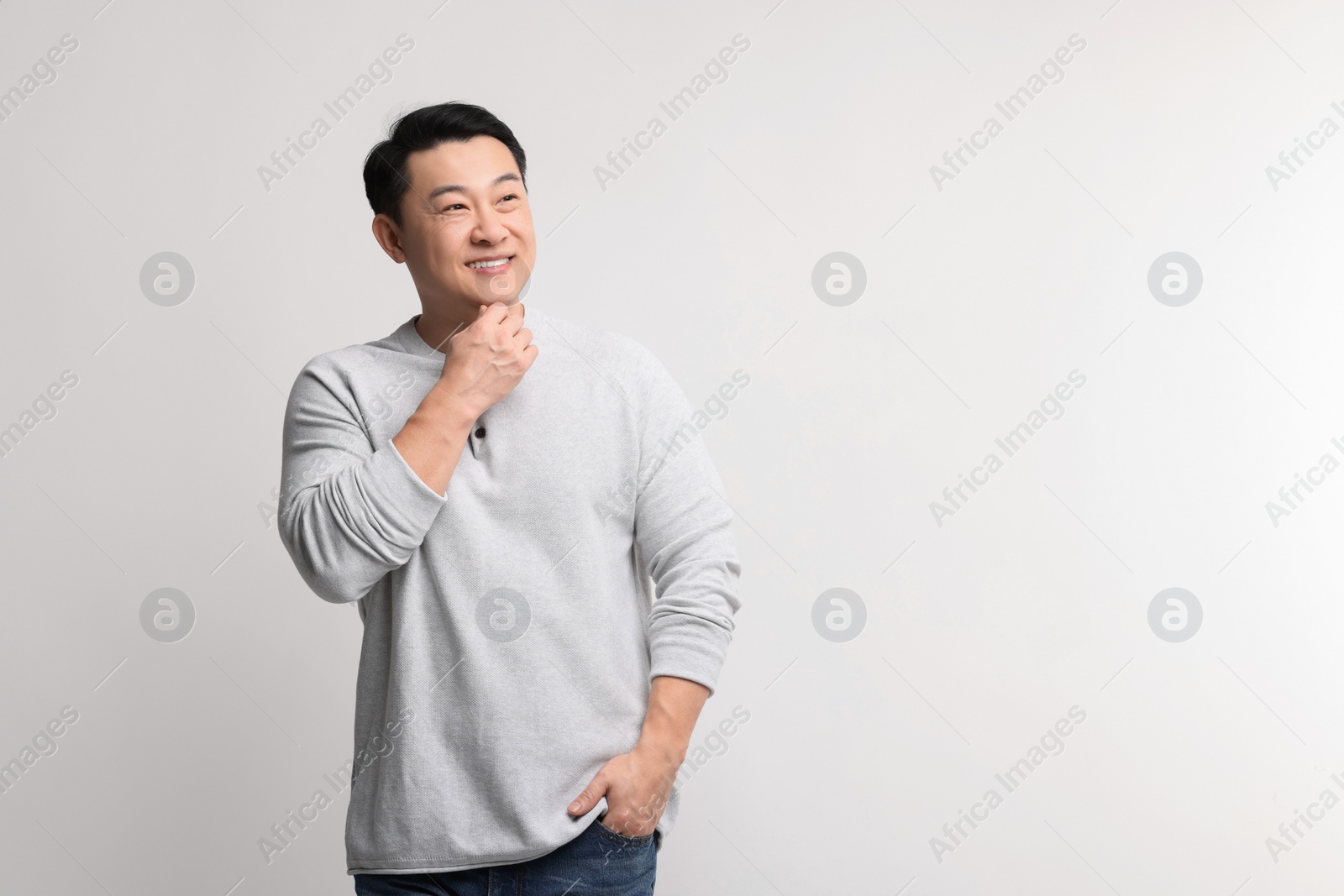 Photo of Portrait of happy man on light background. Space for text