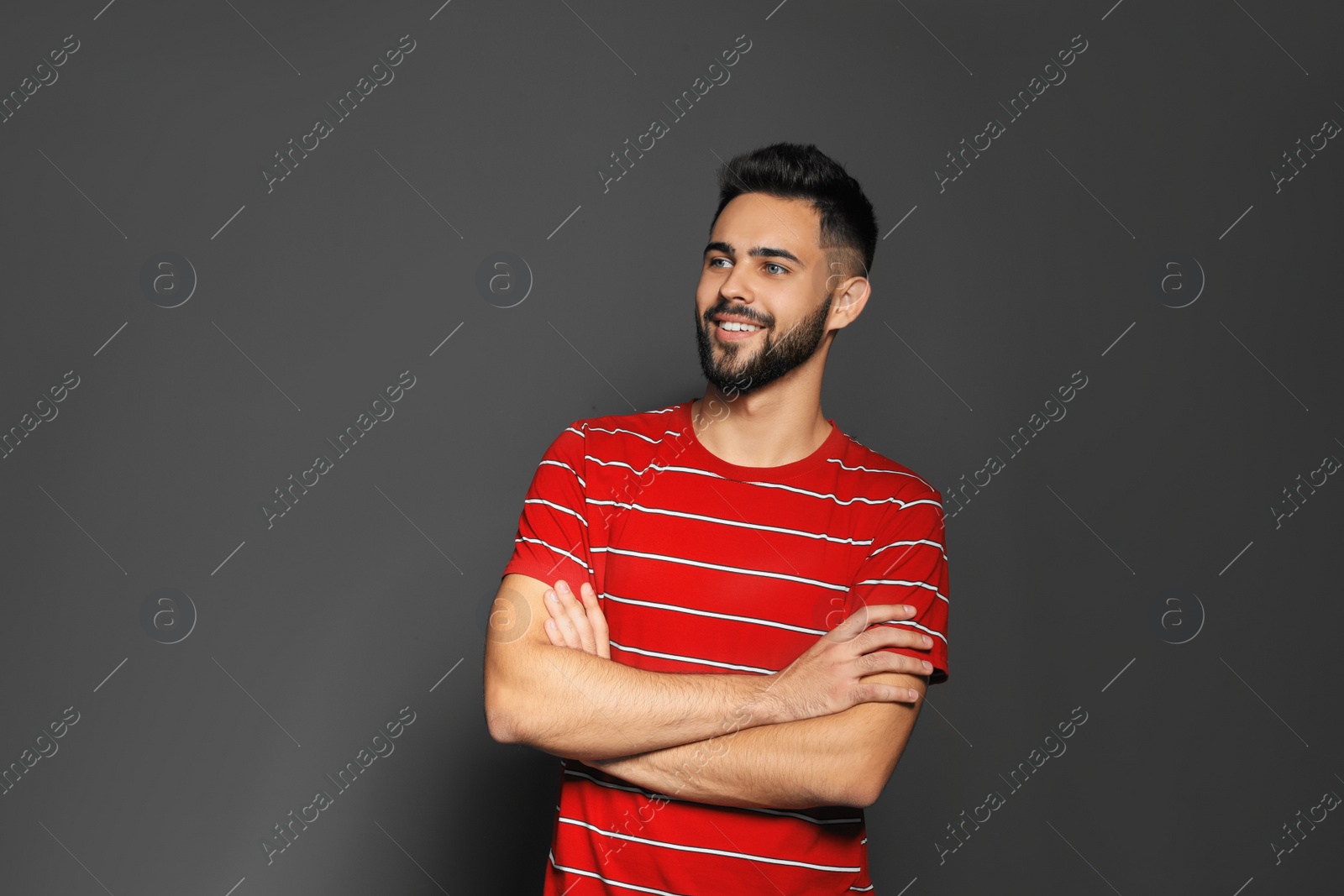 Photo of Portrait of handsome young man on gray background