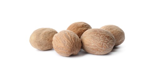 Heap of nutmeg seeds on white background