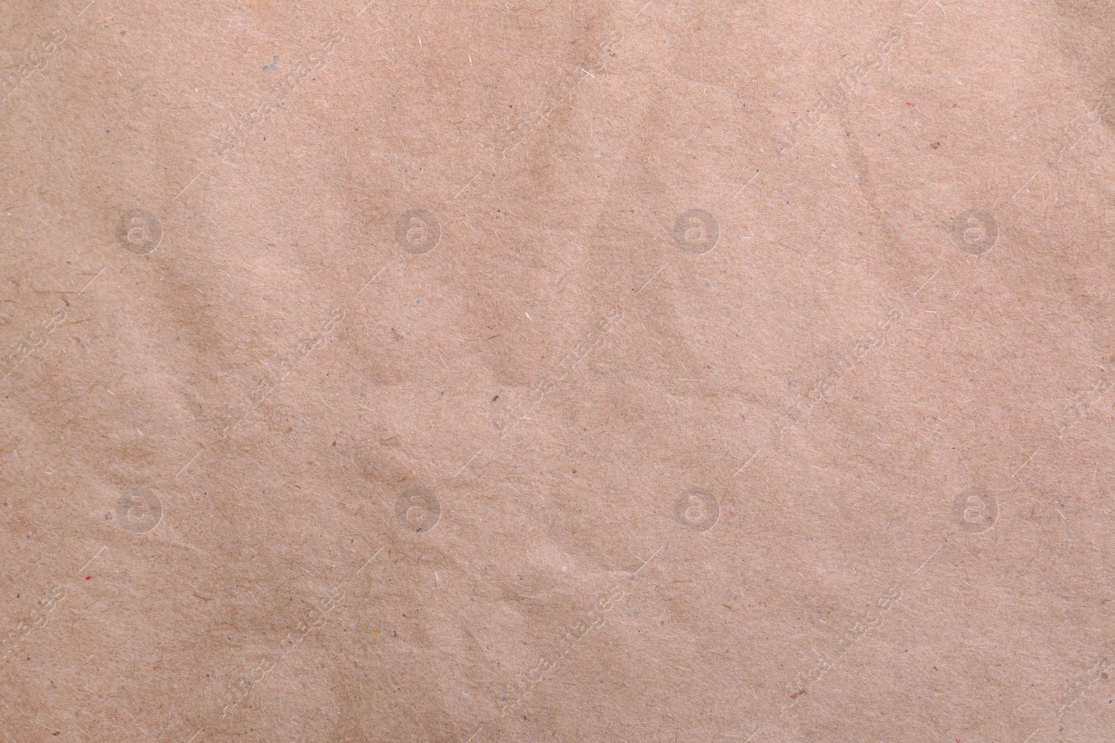 Photo of Texture of kraft paper bag as background, closeup