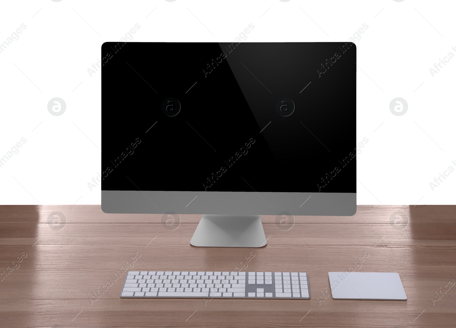 Photo of Modern computer with blank monitor screen and peripherals on wooden table against white background