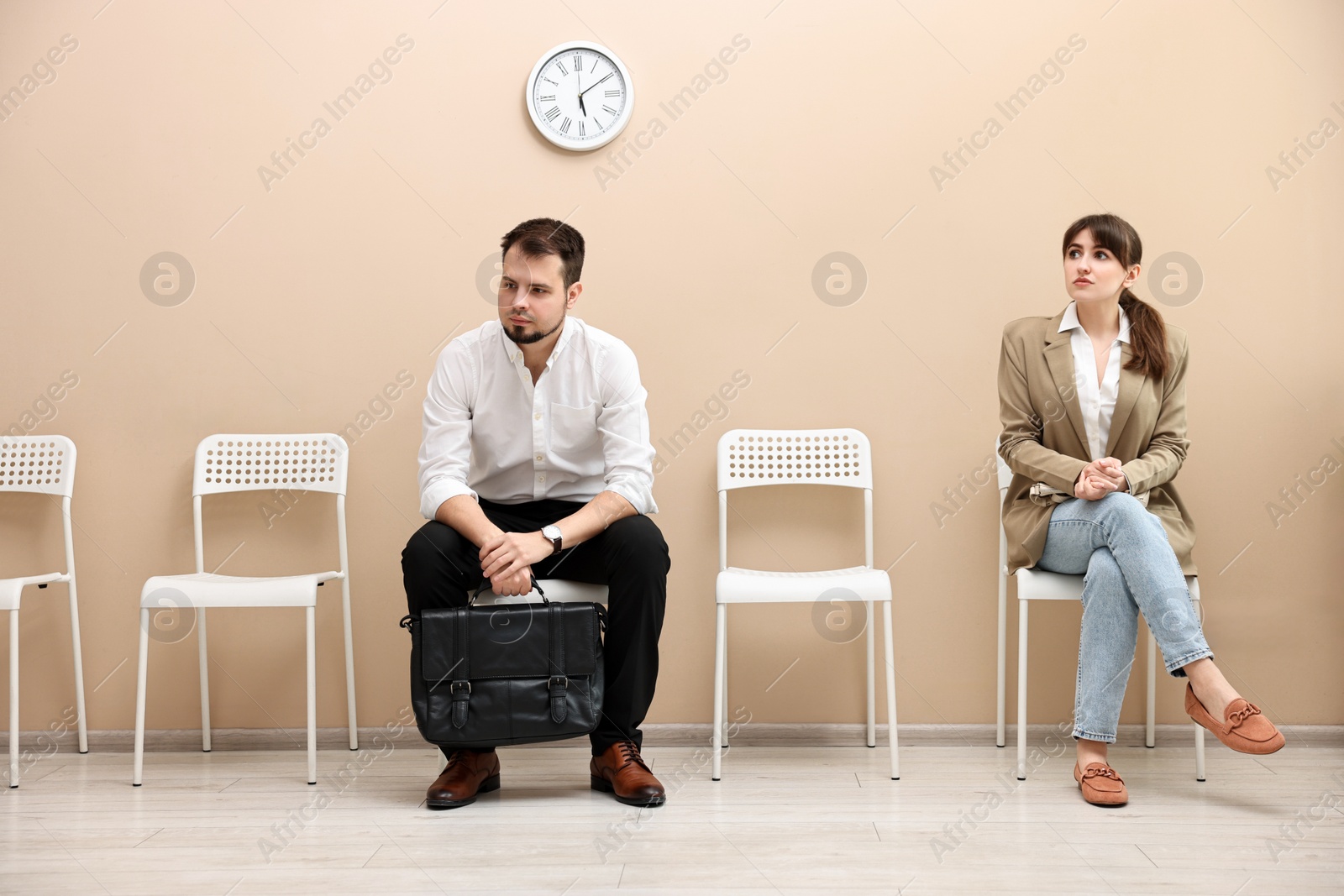 Photo of Man and woman waiting for job interview indoors