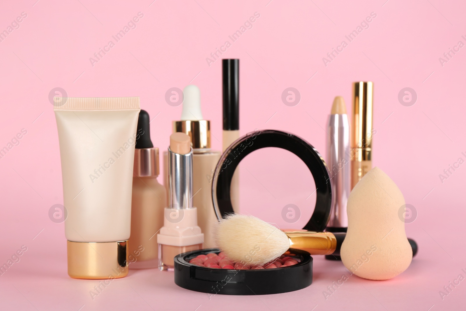 Photo of Foundation makeup products on pink background. Decorative cosmetics