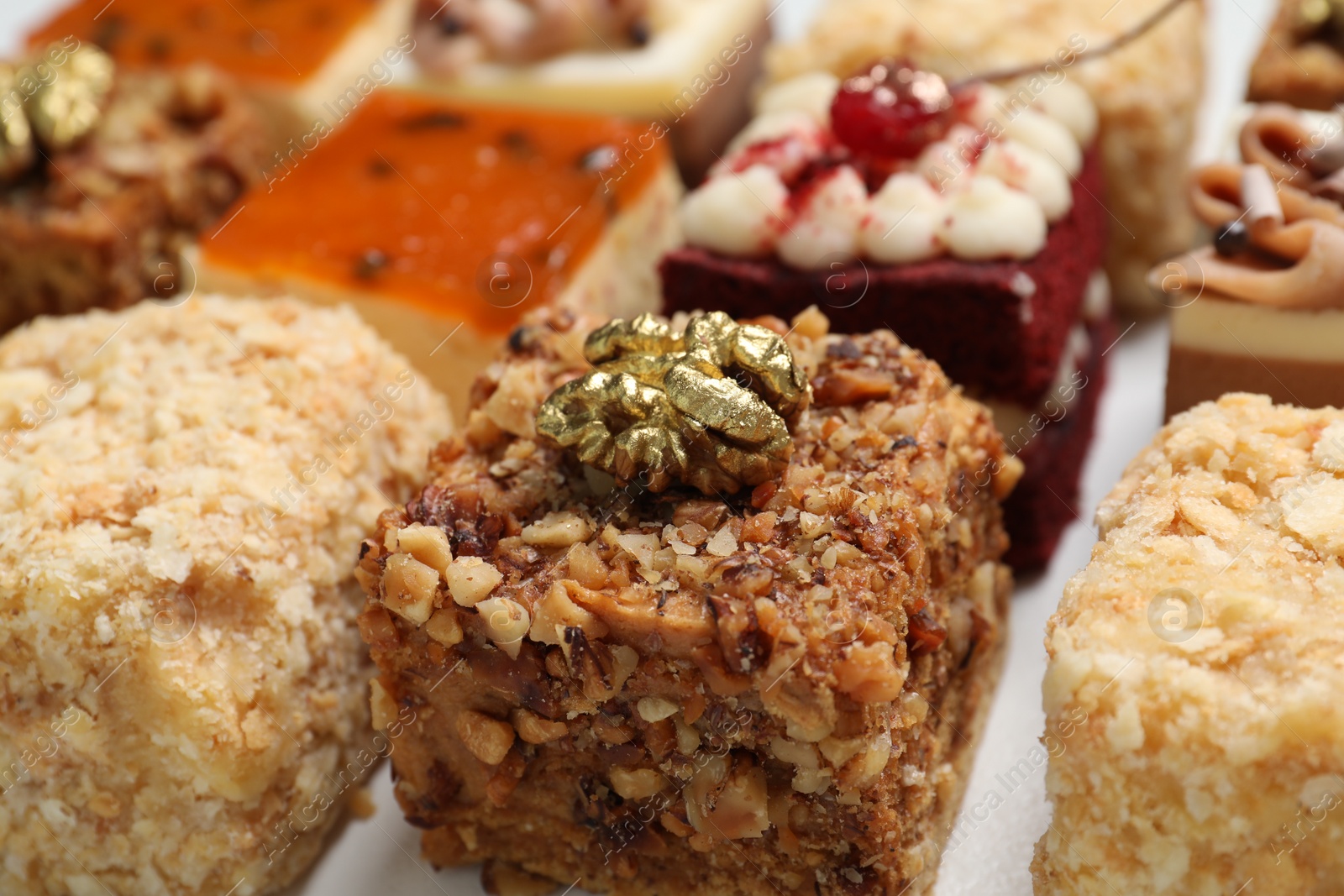 Photo of Pieces of different delicious cakes on table, closeup