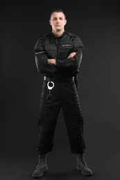 Male security guard in uniform on dark background