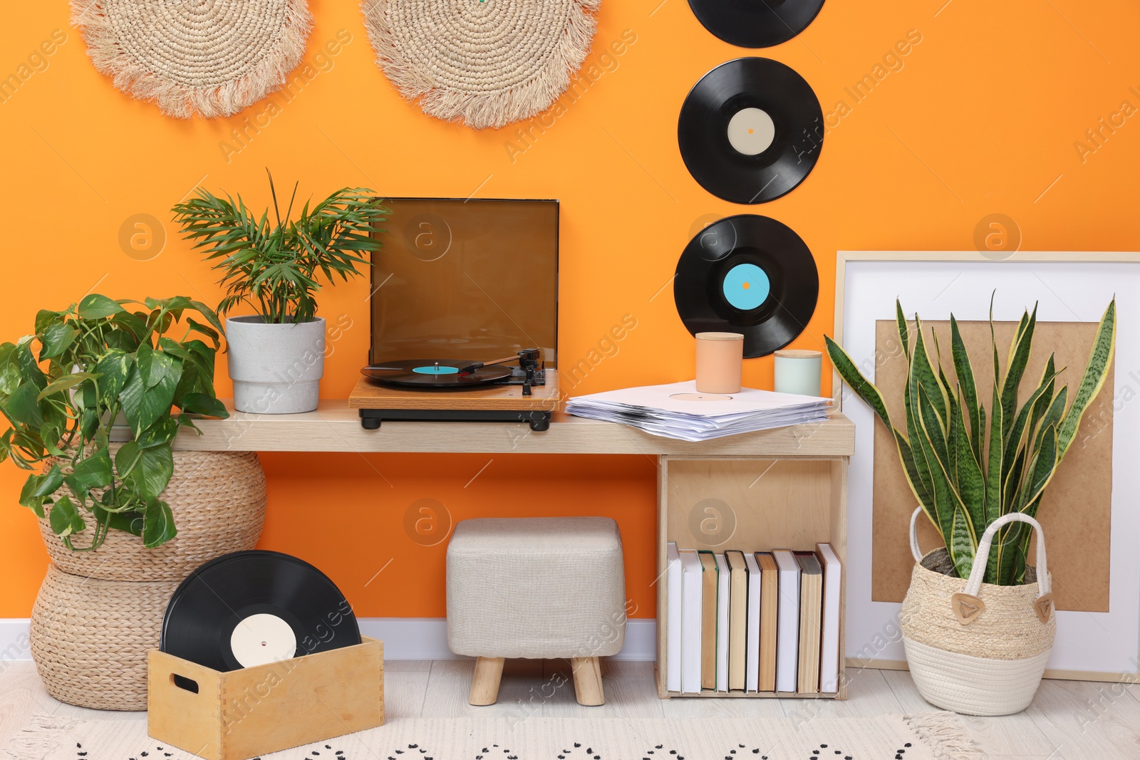 Photo of Stylish turntable with vinyl record on console table in cozy room