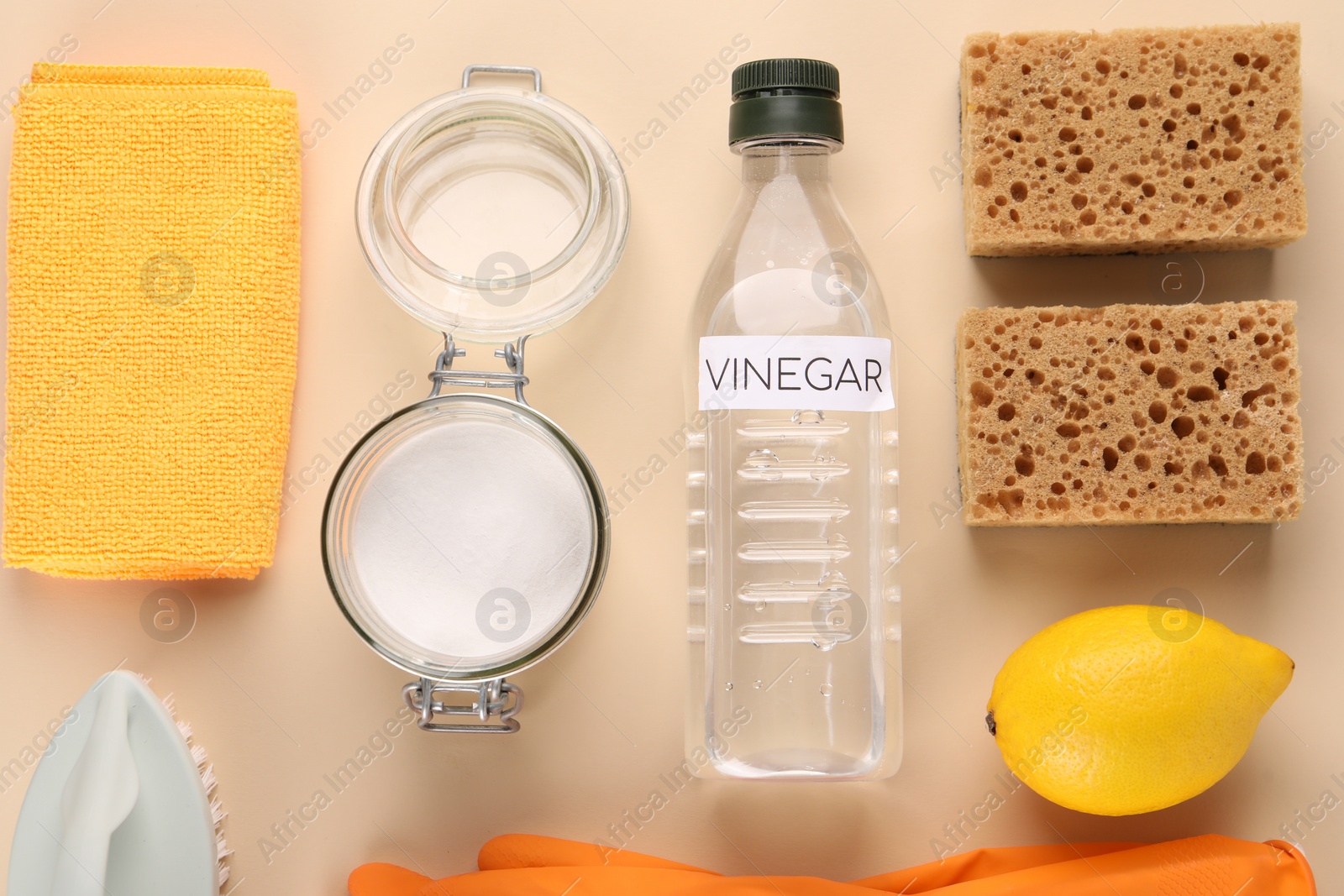 Photo of Eco friendly natural cleaners. Flat lay composition with bottle of vinegar on beige background