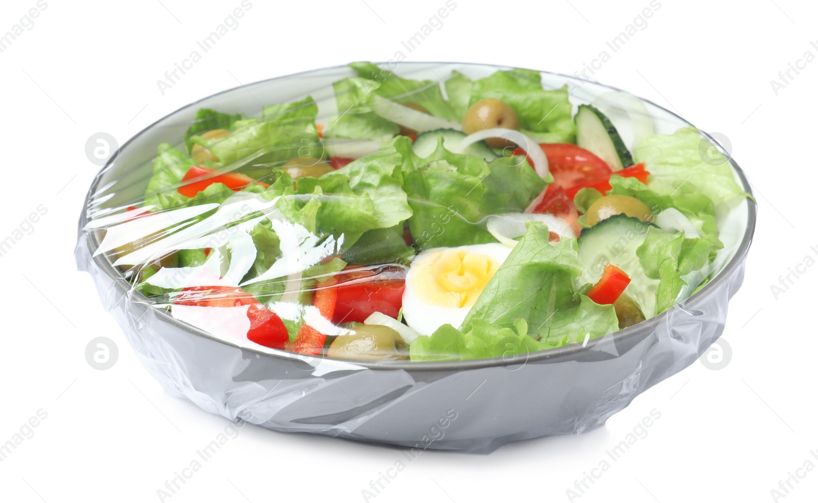 Photo of Bowl of fresh salad wrapped with transparent plastic stretch film isolated on white