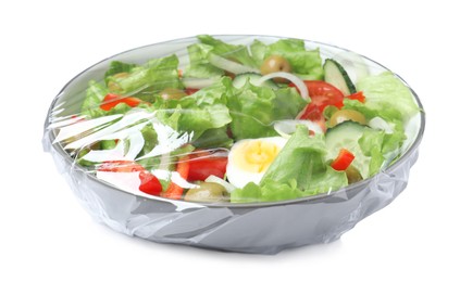 Photo of Bowl of fresh salad wrapped with transparent plastic stretch film isolated on white