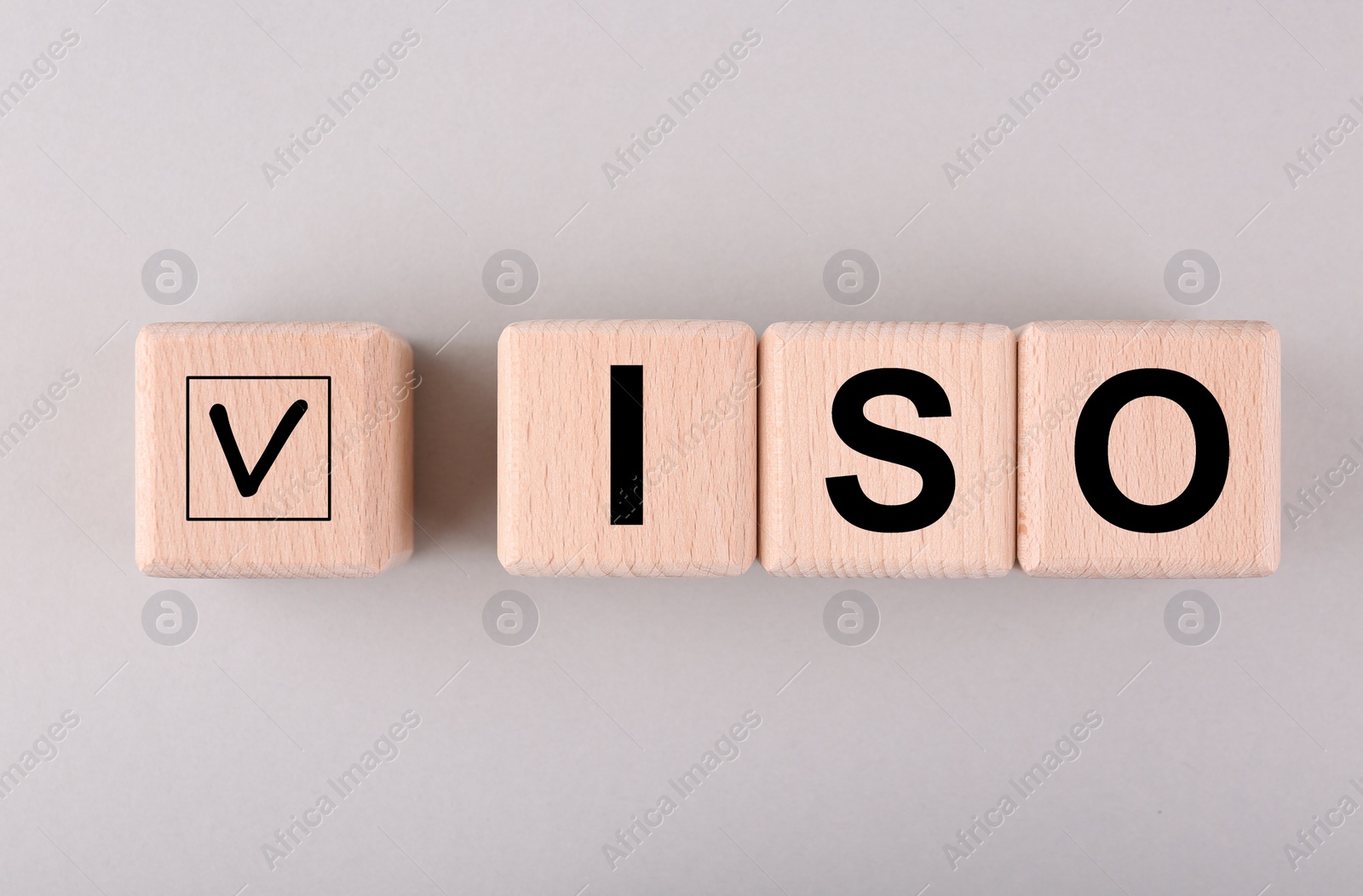 Photo of International Organization for Standardization. Wooden cubes with check mark and abbreviation ISO on light grey background, flat lay